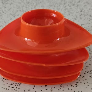 set of four 1970s vintage stackable plastic egg cups in bright orange
