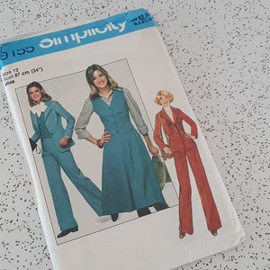May include: A vintage Simplicity sewing pattern for a women's pantsuit. The pattern shows three different styles of pantsuits, one in blue, one in red, and one in a blue dress with a vest. The pattern number is 9100.