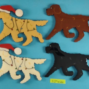 May include: Four wooden dog cutouts in various colors: yellow with Christmas lights and a Santa hat, brown, black, and off-white with Christmas lights and a Santa hat. Each dog is 3.2 inches wide.
