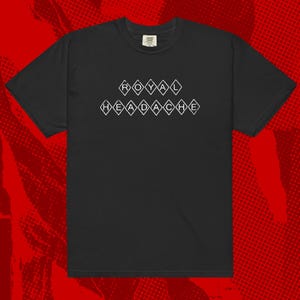 May include: Black t-shirt with the text "ROYAL HEADACHE" in white diamond-shaped letters. The shirt has short sleeves and a crew neck. The background is a red halftone pattern.