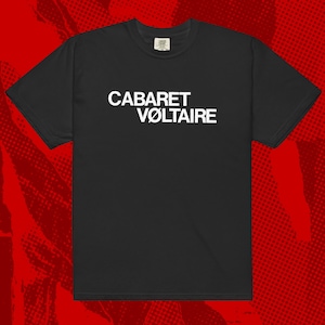 May include: Black t-shirt featuring the white text "CABARET VOLTAIRE". The shirt has a crew neck and short sleeves. The background is a red halftone pattern.