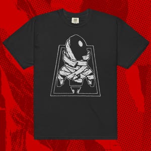 May include: Black t-shirt with a white graphic of a rocket ship wrapped in bandages. The graphic is inside a white triangle.
