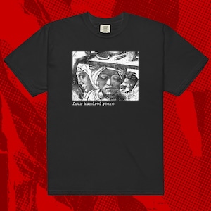 May include: Black t-shirt with a white graphic of three people's faces and the text "four hundred years".