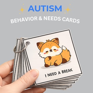 May include: A set of Autism Behavior & Needs Cards held by a hand. The cards feature a cute cartoon fox illustration and the text "I NEED A BREAK". The cards are bound together with a metal ring.