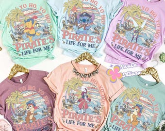 May include: A collection of six colorful t-shirts with rolled sleeves, each featuring a unique pirate-themed graphic. The designs include cartoon characters, palm trees, and the text "YO HO, YO HO, PIRATE'S LIFE FOR ME". The shirts are in various pastel colors.