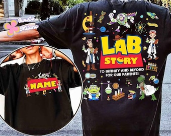 May include: Black t-shirt with a colorful "Lab Story" design featuring cartoon characters, lab equipment, and the text "To infinity and beyond for our patients!" A smaller image on the front has the word "NAME" on a red background.