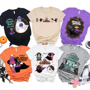 May include: Six short-sleeved t-shirts in black, beige, purple, orange, white, and gray, each featuring Disney-themed Halloween graphics and text including 'Eternal Waltz', 'Virtual Spooktacular', 'Headless Horseman', and 'Dig & Dash' with various characters.