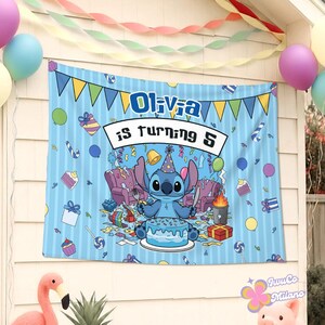 May include: A blue birthday banner with the text "Olivia is turning 5" and a cartoon character holding a fork and knife in front of a cake. The banner has a light blue background with vertical stripes and colorful party decorations.