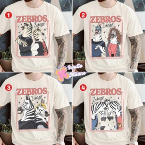 May include: Cream-colored t-shirts featuring the word "ZEBROS" in a retro font, each with a different cartoon zebra design inside a red frame. The designs include zebras in various outfits and poses.
