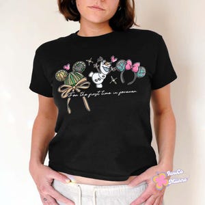 May include: Black crew neck t-shirt with a cartoon design featuring Mickey Mouse ears, a bow, and the text "For the first time in forever." The design includes Olaf from Frozen and hearts.