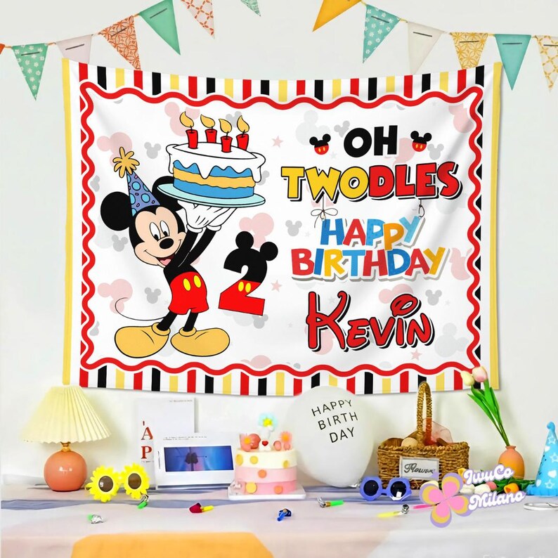 May include: A rectangular birthday backdrop featuring Mickey Mouse wearing a party hat and holding a cake with four candles. The text reads OH TWODLES HAPPY BIRTHDAY KEVIN with a large number 2. The border has red, black, and yellow stripes.