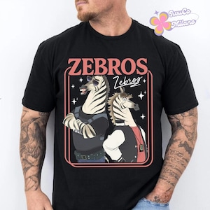 May include: Black t-shirt featuring a cartoon illustration of two zebras. The design includes the word "ZEBROS" in a retro font, with one zebra wearing sunglasses and a police uniform, and the other in a letterman jacket.