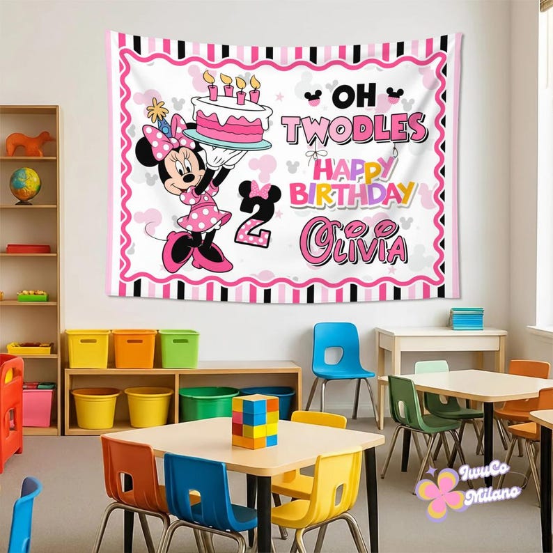 May include: A rectangular fabric wall tapestry featuring a white background with a pink and black striped border. It displays a cartoon mouse character in a pink polka dot dress holding a birthday cake, with the text OH TWODLES HAPPY BIRTHDAY OLIVIA.