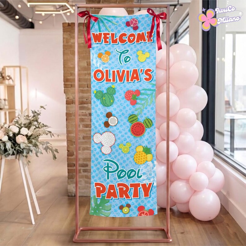 May include: A vertical rectangular banner with a light blue background featuring a repeating pattern of fruit-shaped Mickey Mouse icons. The text reads WELCOME TO OLIVIA'S POOL PARTY in red letters. The banner is tied to a copper metal frame with red ribbons.