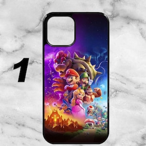 May include: Black phone case featuring a vibrant graphic of characters from a popular video game. The design includes Mario, Luigi, Princess Peach, and Bowser, set against a colorful, fantasy background. The case has a black border.