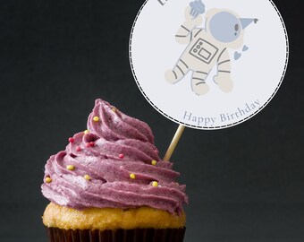 May include: A purple cupcake with yellow and red sprinkles topped with a round white cake topper that says "Leo's 4th Party" with a cartoon astronaut holding a cupcake and the text "Happy Birthday".