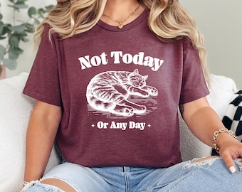 May include: Maroon t-shirt with the text "Not Today Or Any Day" and a white illustration of a sleeping cat. The shirt is a heather maroon color.