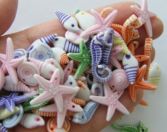 100 Blue random sea themed acrylic charms