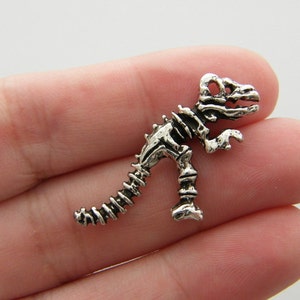 4 Dinosaur skeleton charms antique silver tone A964