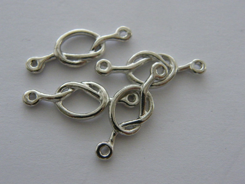 BULK 30 love knot connector charm antique silver tone R111