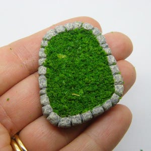 May include: A miniature stone-walled pond with a green moss-like surface. The pond is approximately 5 cm in diameter and is ideal for a miniature garden or fairy garden.