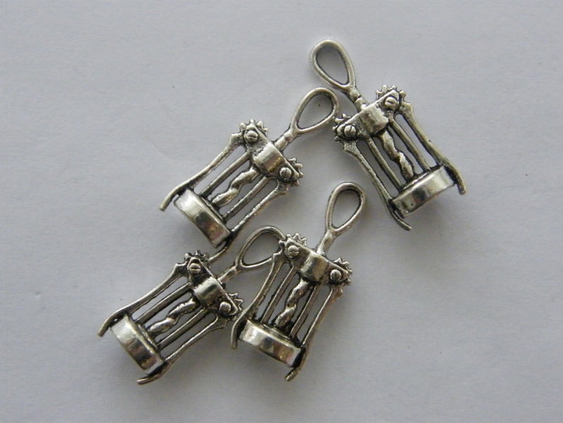 May include: Four silver-toned metal corkscrew charms. Each charm is a miniature replica of a traditional corkscrew.