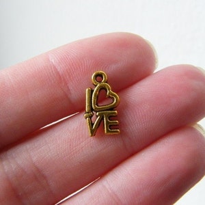 34 LOVE charms antique gold tone M242 image 1