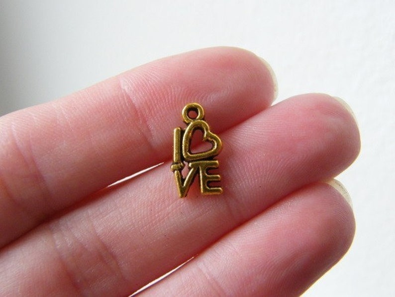 34 LOVE charms antique gold tone M242 image 1