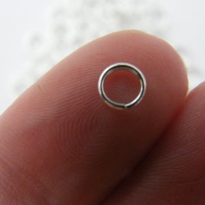 May include: A silver jump ring, a small metal ring used for connecting jewellery components.