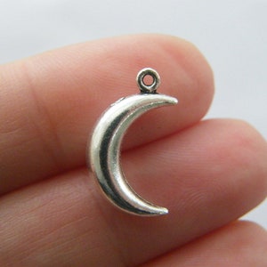 May include: Silver crescent moon charm with a loop for attaching to jewellery or other crafts.