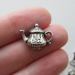May include: Silver charm in the shape of a teapot with the words "tea time" on the side.