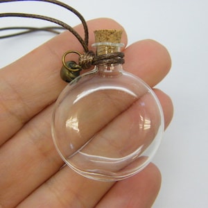 1 Round clear glass bottle with removable cork brown cord GB09