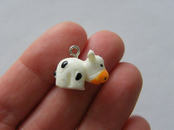 4 Cow Charms White Resin A1116 -  Israel