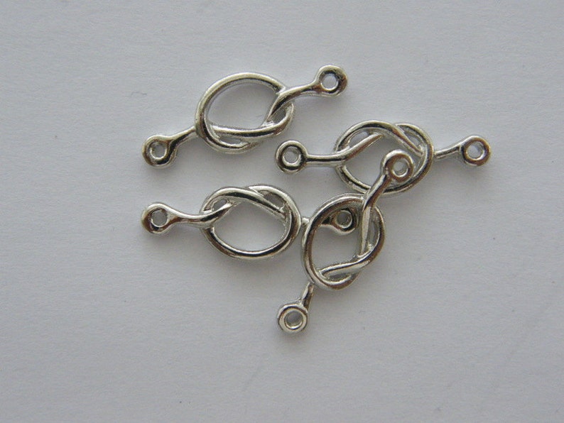 BULK 30 love knot connector charm antique silver tone R111