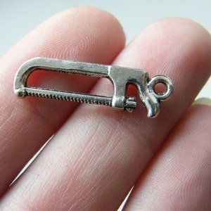 12 Saw charms antique silver tone P595