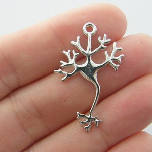 May include: Silver charm shaped like a neuron, a type of nerve cell, with a loop at the top for attaching to a necklace or bracelet.