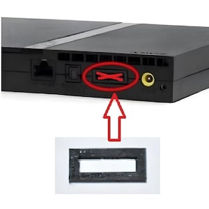 May include: A black PlayStation 2 console with a red circle highlighting the memory card slot. The image also shows a close-up of a black memory card.