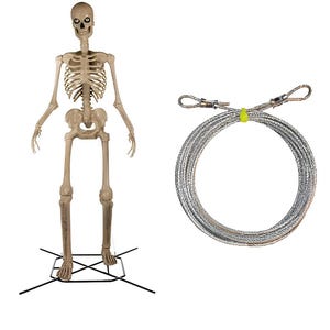 May include: A life-size, beige plastic skeleton stands on a black metal base. A coiled, silver-colored wire rope with loop ends is next to the skeleton. The wire is secured with a yellow plastic tie.