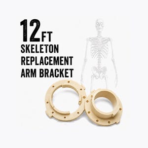 May include: Two beige circular plastic arm brackets for a 12ft skeleton. The text 12FT SKELETON REPLACEMENT ARM BRACKET is printed in black. The brackets feature a central circular opening surrounded by a flat flange with multiple small screw holes.