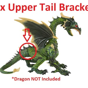 May include: A green and gold dragon figurine with dark green wings and red eyes. The image includes the text "1x Upper Tail Bracket" and "*Dragon NOT Included". A red arrow points to the dragon's tail.