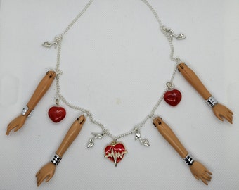 Doll arms , hearts and heels charm necklace