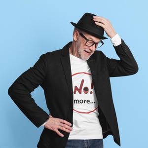 NO! MORE... is a wearable protest against escalation, conflict, noise and power without reflection.

This unisex graphic t-shirt combines raw hand-drawn typography with a human scream hidden inside the message — turning a simple phrase into a visual reaction.