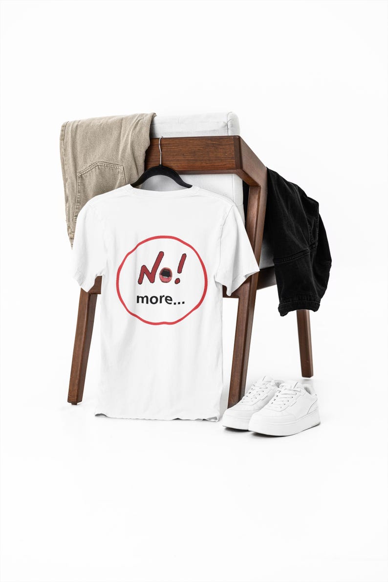 NO! MORE... is a wearable protest against escalation, conflict, noise and power without reflection.

This unisex graphic t-shirt combines raw hand-drawn typography with a human scream hidden inside the message — turning a simple phrase into a visual reaction.