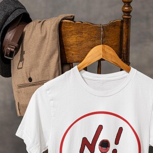 NO! MORE... is a wearable protest against escalation, conflict, noise and power without reflection.

This unisex graphic t-shirt combines raw hand-drawn typography with a human scream hidden inside the message — turning a simple phrase into a visual reaction.
