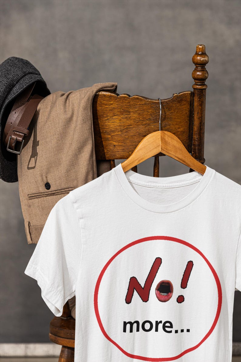 NO! MORE... is a wearable protest against escalation, conflict, noise and power without reflection.

This unisex graphic t-shirt combines raw hand-drawn typography with a human scream hidden inside the message — turning a simple phrase into a visual reaction.