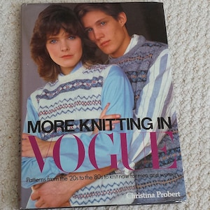 May include: A book cover featuring a couple wearing knitted jumpers. The title of the book is "More Knitting in Vogue" and the subtitle is "Patterns from the '20s to the '80s to knit now for men and women." The author's name is Christina Probert.