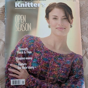 May include: Knitter's magazine cover featuring a woman wearing a colorful knitted sweater with the text "Open Season" and "Through Thick & Thin Slipping Away Eyelets - the Hole story -"