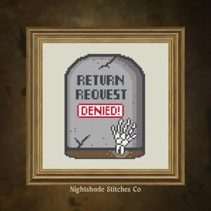 May include: Cross-stitch artwork in a wooden frame. The design shows a gray tombstone with the words "RETURN REQUEST DENIED!" in pixelated text. A skeletal hand emerges from the ground. The artist's name, "Nightshade Stitches Co," is at the bottom.
