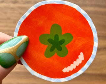 Tomato Sticker – Large Red Tomato with Green Stem on Blue Gingham Background