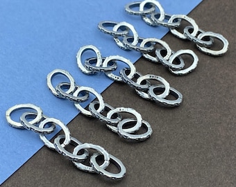 May include: Four silver-toned metal chain segments, each consisting of five interlocking oval links. Each individual link features a textured surface and is clearly stamped with the hallmark 925, indicating sterling silver composition.